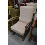 A pair of traditional stained frame and upholstered rocking chairs