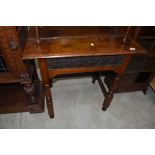 A period oak side table, having lincrusta style frieze panel