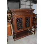 A 19th Century oak display cabinet top, having coloured glass door, lion mask and brass ring