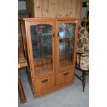 A vintage laminate display cabinet, approx dimensions W83cm H125cm D40cm