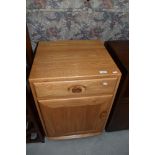 A light Ercol bedside cabinet