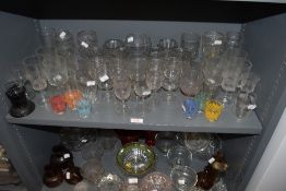 A selection of cocktail wine and party glasses including 50's printed shot glasses