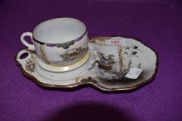 A Chinese eggshell tennis set or tea cup and saucer decorated with stalks and river scene