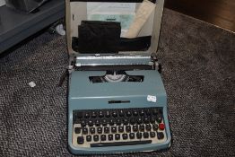 A baby blue Olivetti type writer Lettera 32