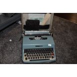 A baby blue Olivetti type writer Lettera 32