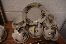 A part tea service having purple floral print