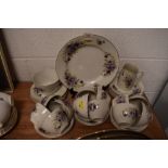 A part tea service having purple floral print