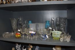A selection of clear cut and colour glass wares including vaseline and paper weights