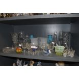 A selection of clear cut and colour glass wares including vaseline and paper weights