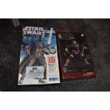 An X-men cyclops vinyl model kit and an empty Star wars Darth Vader limited edition figure box.