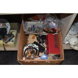 A box full of miscellaneous items,keyrings ,coins,books including annuals and more.