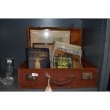 A selection of piano and sheet music in a leather bound suitcase and etching of Lancaster