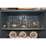 A selection of pressed and clear cut glass wares including light shades claret jug decanter etc