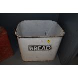 A vintage enamel bread bin with name badge