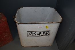 A vintage enamel bread bin with name badge