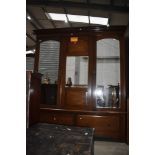 An Edwardian mahogany and inlaid two piece bedroom suite comprising mirror door wardrobe and