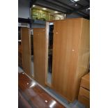 A pair of vintage golden oak mirror door wardrobes , early Stag