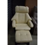 A modern cream stressless style armchair and footstool