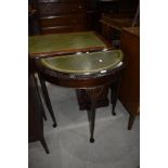 A reproduction half moon hall table, with skiver top, width approx. 76cm