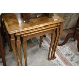 An early 20th Century walnut nest of three tables