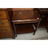 A vintage mahogany tea trolley