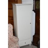 A modern white finished MDF wardrobe with lower shelf and drawer base, dimensions approx. W66cm