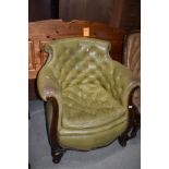 A period leather tub armchair on wood frame having button back and seat