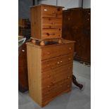 A modern pine chest of five drawers and a similar three drawer bedside chest