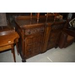 A mid 20th Century oak sideboard having ledge back, frieze drawers and double cupboard under,