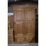 A modern natural pine wardrobe having drawer base, approx. width 122cm depth 63cm height 204cm,