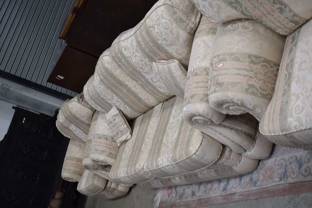 A late 20th Century three piece lounge suite having cream foliate upholstery