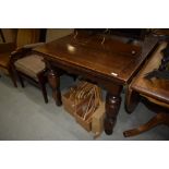 A mid 20th Century oak drawer leaf dining table