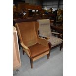 A vintage mustard dralon wing back chair and a modern wood frame armchair