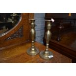 A pair of traditional brass candlesticks