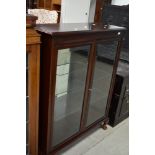 A reproduction mahogany display cabinet having internal glass shelves