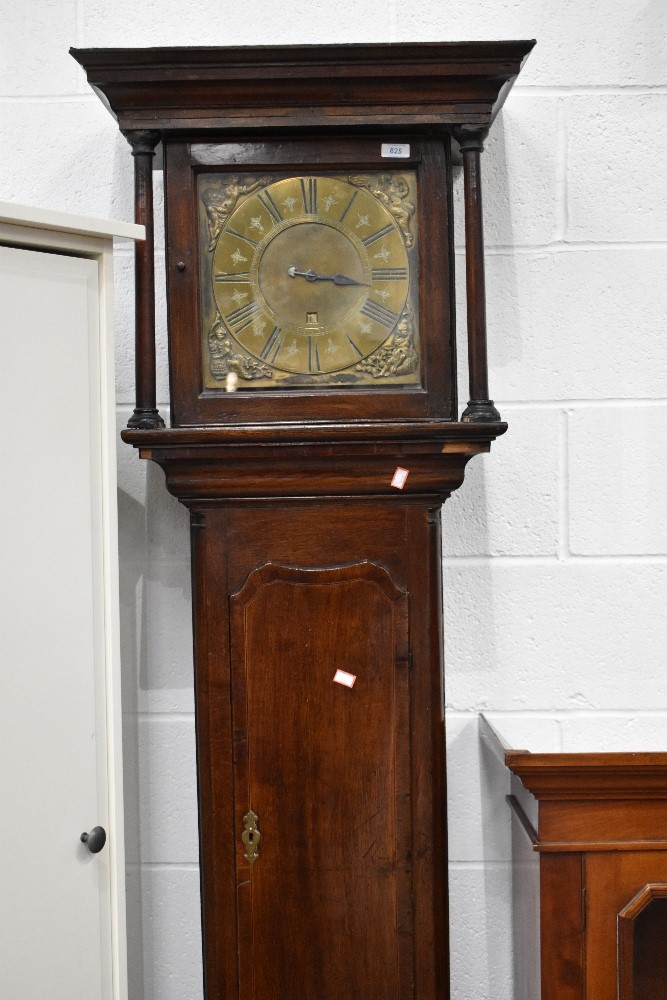 An oak long case clock, having brass dial with 30 hour movement, named Lomas , Poolton, with figural