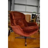 A vintage Eames style lounge chair, upholstered in orange dralon