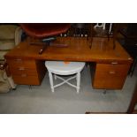 A vintage office desk, in teak, highly polished, with Chromed handles and legs, and very similar