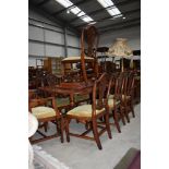 A reproduction Regency extending dining table and eight (six plus two) chairs