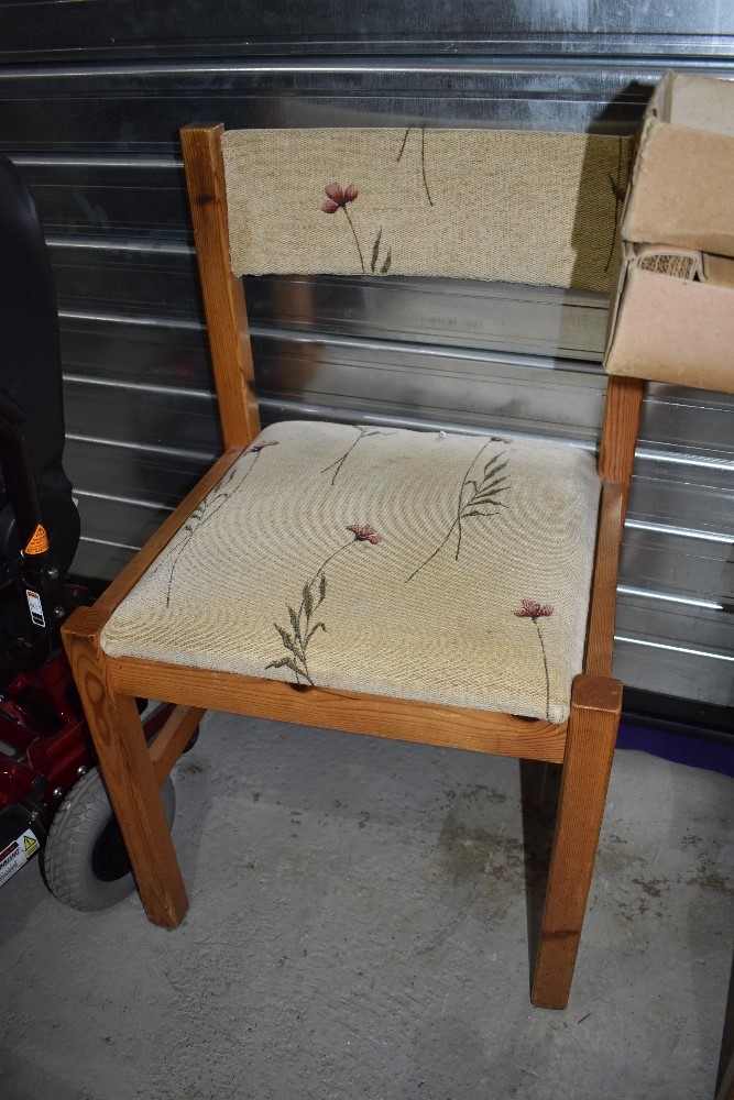 A set of four modern pine dining chairs with upholstered seats and back rails