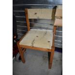 A set of four modern pine dining chairs with upholstered seats and back rails