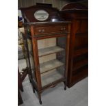 An Edwardian mahogany and inlaid narrow display cabinet having mirror back and frieze drawer,