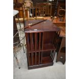 A reproduction mahogany effect revolving bookcase