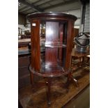 An Edwardian dark mahogany and inlaid revolving bookcase, a nice quality piece, varnish perishing