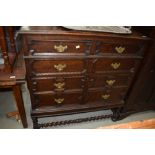 An early 20th Century Jacobean inspired chest on stand in dark oak