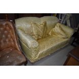 An early 20th Century settee having later damask style loose cover, width approx. 183cm