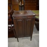 An early 20th Century mahogany enclosed music cabinet