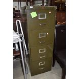 A vintage metal four drawer filing cabinet