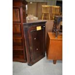 A period oak corner wall cupboard