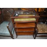 A traditional mahogany bijouterie table having display top over three shelves, simplistic frame